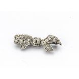 An art deco bow brooch, set with old cut and rose cut diamonds to white metal with pierced back,