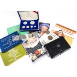 A collection of modern coins, including several £5, £1 and others, along with proof sets from