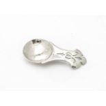 An Arts & Crafts style tea caddy spoon, having hammered silver circular bowl and shaped and