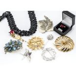 A quantity of signed costume jewellery, by Monet, Trifari, Swarovski etc