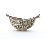 An early 20th Century Indian silver dish, elliptical having bird head terminals and body ornately