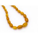 An amber bead necklace, the toffee coloured graduated beads with gilt barrel clasp, 27g, 48cm