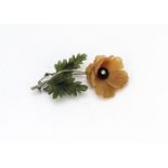 An 18ct gold diamond and hardstone carved floral brooch, the chalcedony flower with onyx centre