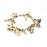 A 9ct gold curb linked charm bracelet, with a quantity of charms including a pair of stilettoes, a