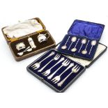 A cased George V silver three piece cruet set by Hukin & Heath, together with a cased set of six