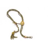 An Edwardian yellow metal lapel fob chain, with accompanying tassel and lozenge slide marked 9ct