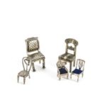 Five 20th Century miniature chairs, two larger white metal chairs, and three smaller marked 925 (5)