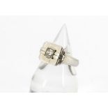 An art deco diamond set white gold signet ring, the brilliant cut in tablet setting with stepped