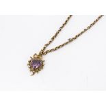 A 19th Century 9ct gold amethyst and seed pearl heart shaped pendant, with bow shaped bale on a