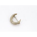 A diamond set crescent brooch, the old cut stones set with smaller modern brilliant cuts, all in