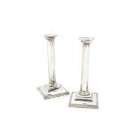 A pair of George V silver filled candlesticks by ISG, square bases with octagonal columns, some