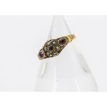 A Victorian 15ct gold garnet and seed pearl posy ring, with scroll setting and engraved shoulders