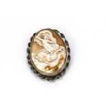 A 19th Century cameo brooch, of classical maiden upon two dolphins within calm sea within white