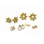 A collection of gold and yellow metal gem set earrings and pendants, including two pairs of flower