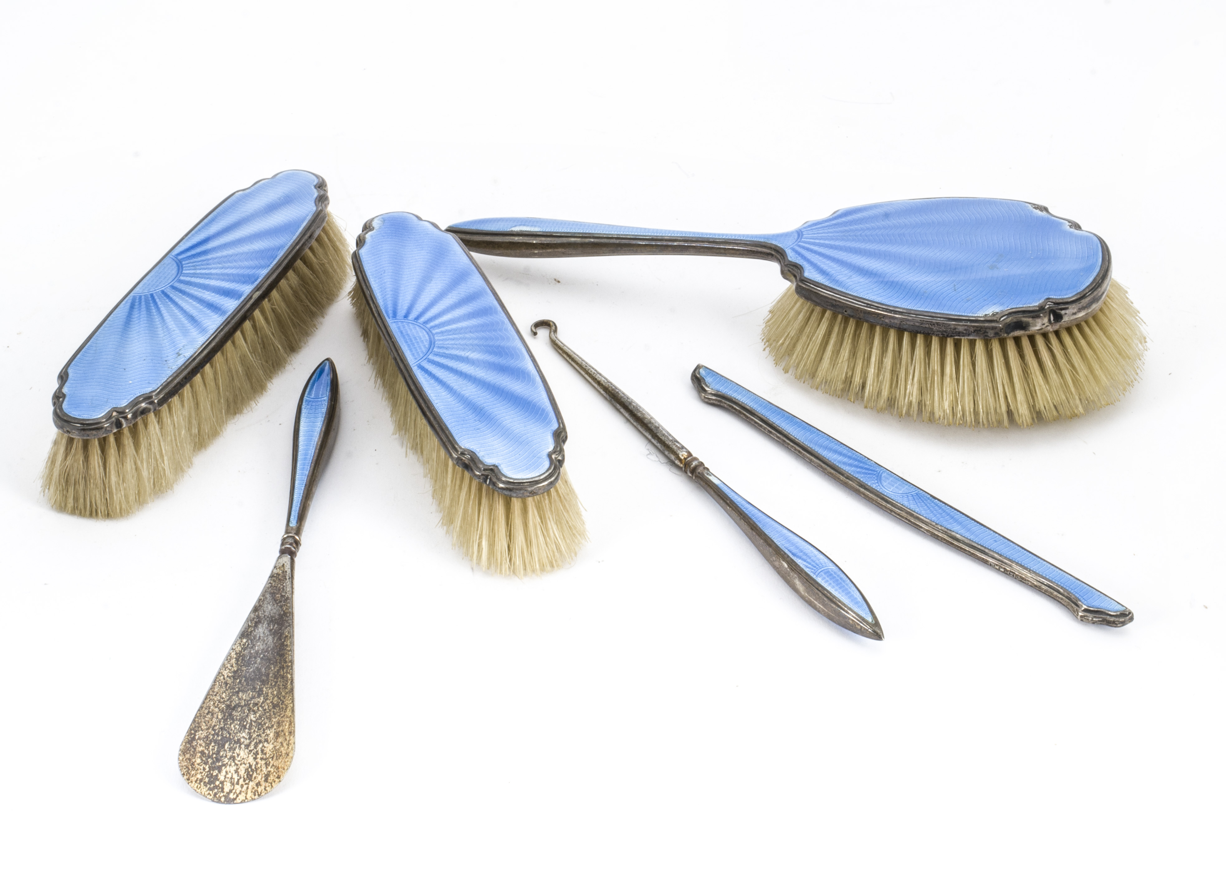 An Art Deco silver and guilloche dressing table set, comprising hair brush, pair of clothes brushes,