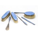 An Art Deco silver and guilloche dressing table set, comprising hair brush, pair of clothes brushes,
