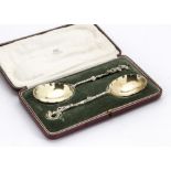 A pair of cased Edwardian silver spoons by Elkington & Co, the ornate serving spoons in red and gilt