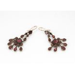 A pair of 19th Century garnet foil backed drop earrings, the gold mounted red gemstones supporting a