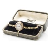 An early 20th Century 9ct gold cased lady's wristwatch, on an expanding strap marked 18ct, in