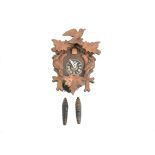 A modern German wooden cuckoo clock, chalet case with birds and leaves, pineapple weights, 23.5 cm