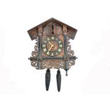 A 19th Century Black Forest carved Trumpeter wall clock, chalet case with scroll and leaf