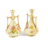 A pair of Royal Worcester twin-handled vases, painted with flowers on a blush ivory ground and