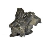 An Inuit carved soapstone figure of a man and a seal, 4116 carved to base with remnants of