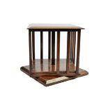 An antique rosewood table-top revolving bookcase, bevelled top, slatted sides, plinth base, 28 cm