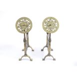 A pair of Victorian brass andirons, each decorated with classical urn and vine leaves, and pierced