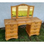 A pine dressing table, kneehole flanked by four drawers to each side, 145 cm wide x 44 cm deep x