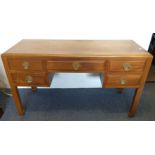 A Chinese teak desk, one long and four short drawers, panelled sides and reverse, 137 cm wide x 58