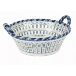 A 20th Century Makkum blue and white ceramic twin-handled pierced basket, decorated with fruit still
