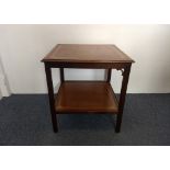 A mahogany two-tier square table, each tier with tooled brown leather inserts, 60 cm square x 67