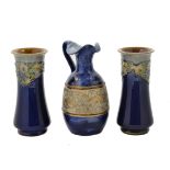 A pair of 20th Century Royal Doulton vases, waisted bodies, tubelined floral decoration on cobalt