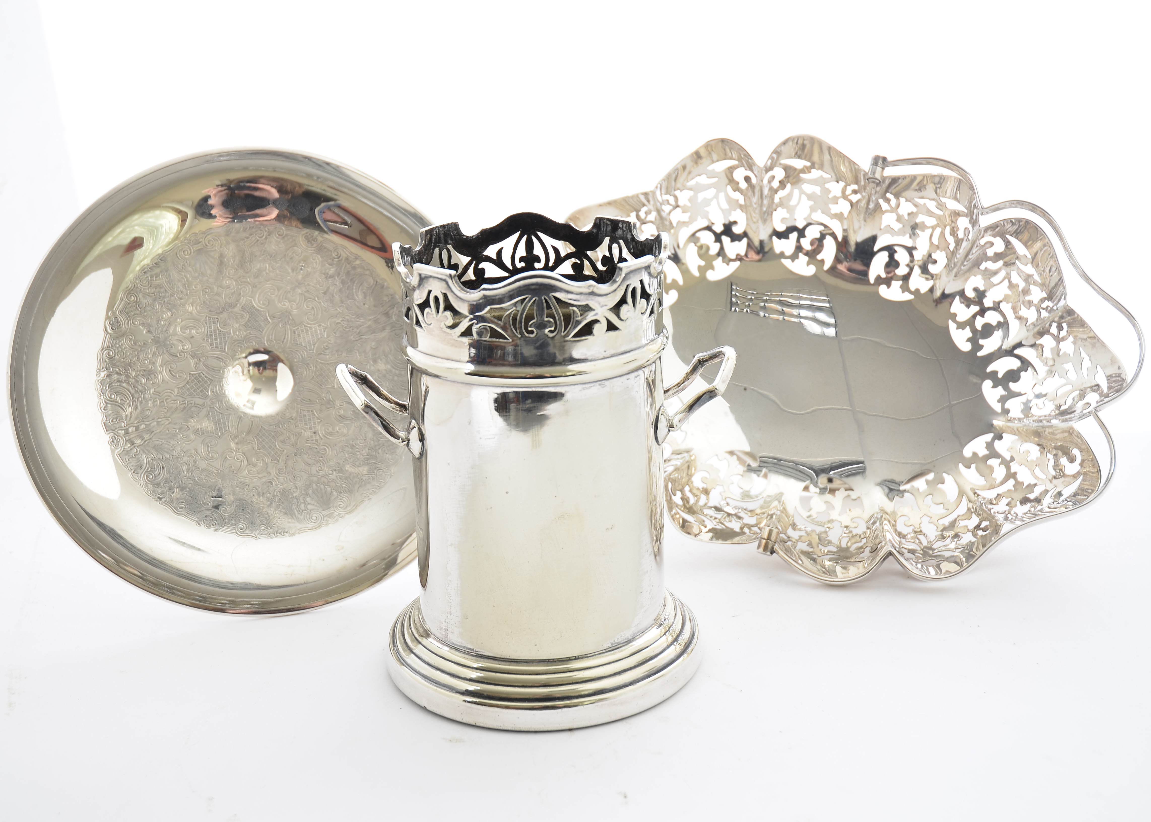 A 20th Century silver plated bottle sleeve, with two handles and pierced decoration, 18 cm high,