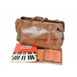 A brown leather Gladstone bag with brass fittings, length 50 cm, and a leather satchel and