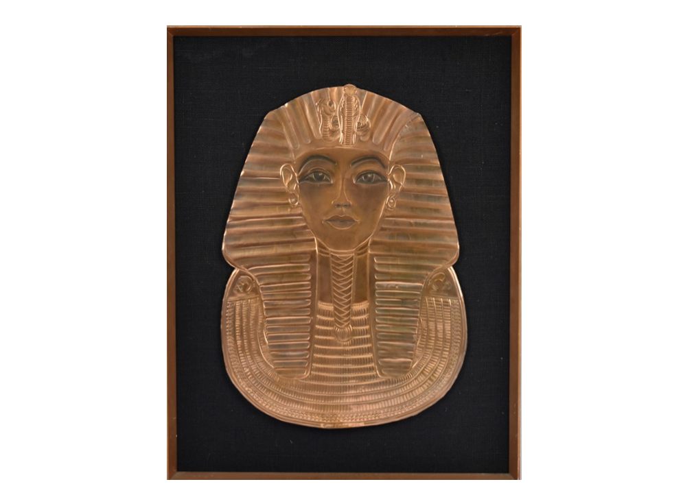 A 20th Century copper relief panel of Tutankhamun's death mask, 51.5 cm x 35.5 cm, framed