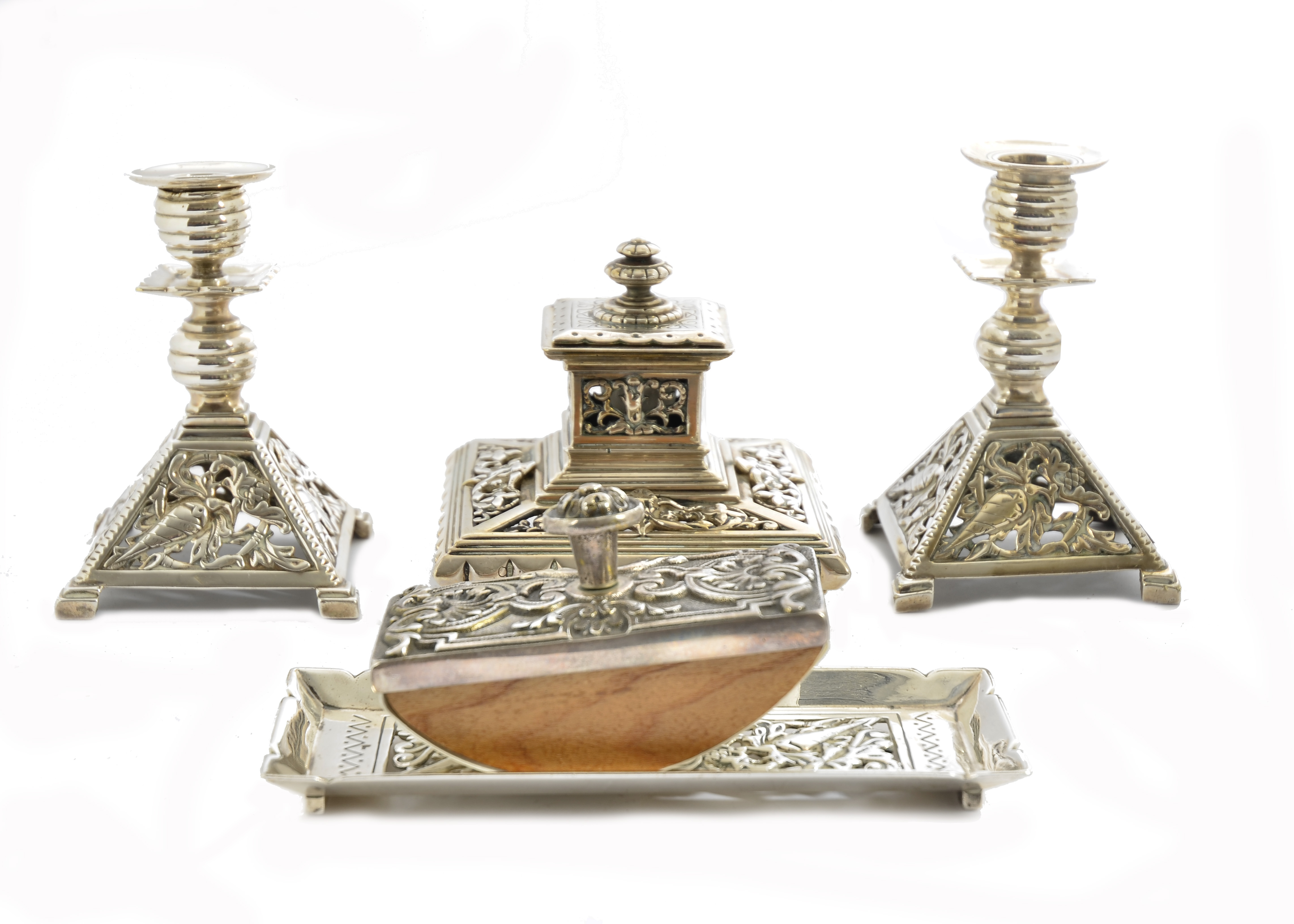 A pair of silver plated candlesticks with matching pen dish, pierced scroll and shell decoration,