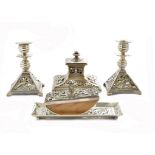 A pair of silver plated candlesticks with matching pen dish, pierced scroll and shell decoration,