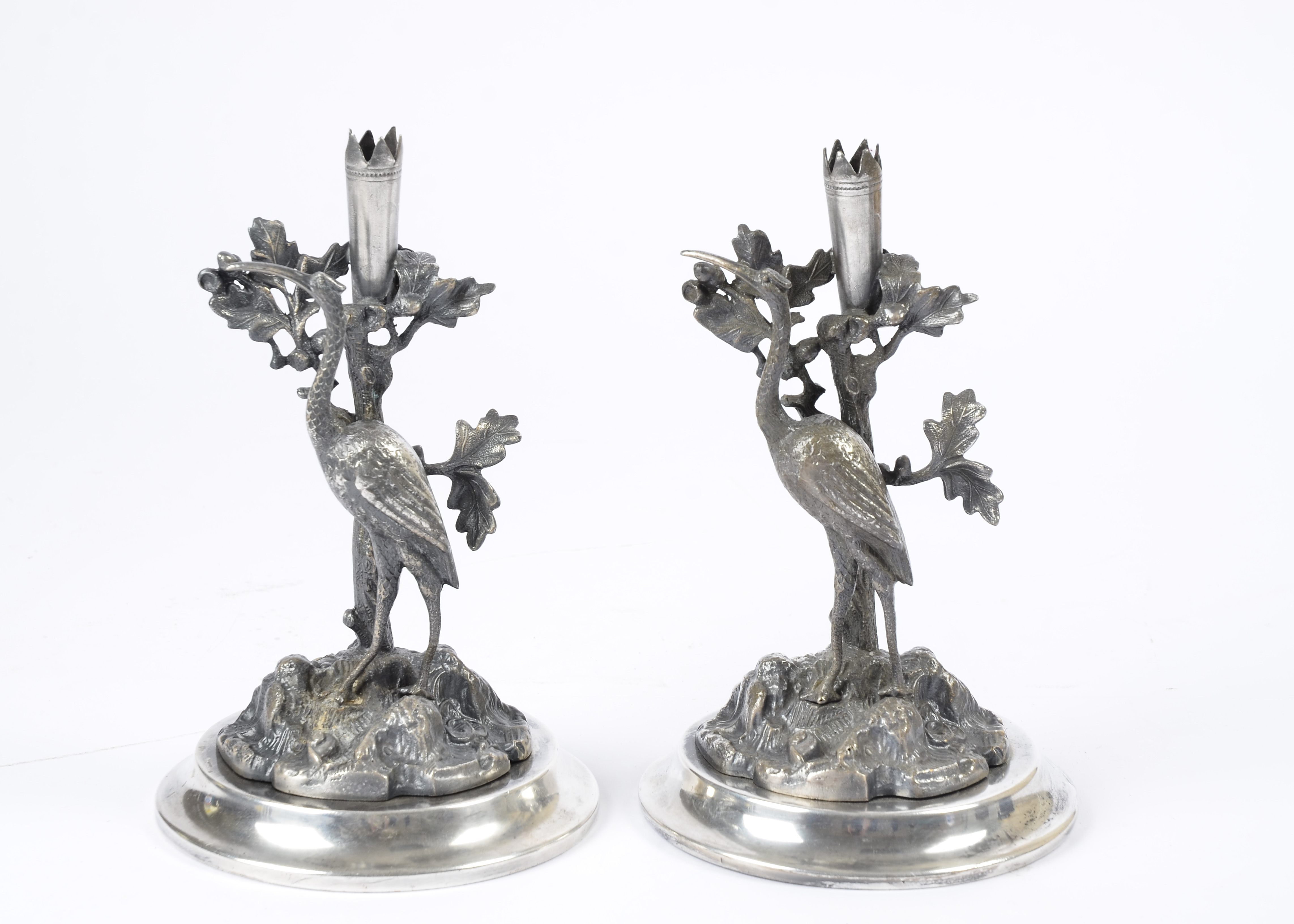 A pair of 19th Century silver plated candlesticks modelled as cranes on a rock by Deykin & Sons,