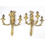 A pair of Louis XVI style ormolu three branch wall sconces, each with acanthus, grape and ribbon