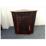 A 19th Century carved mahogany corner cabinet, foliate and scroll decoration, single door