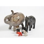 A collection of animal models, comprising numerous elephants in ebony, glass, hard stone, brass