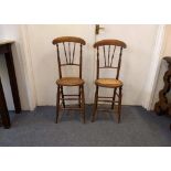 A pair of Victorian beech correction chairs, caned seats, spindle backs, turned supports (one af) (