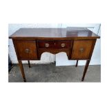 A 19th Century mahogany sideboard, single drawer flanked by two cupboards, shaped top and apron,