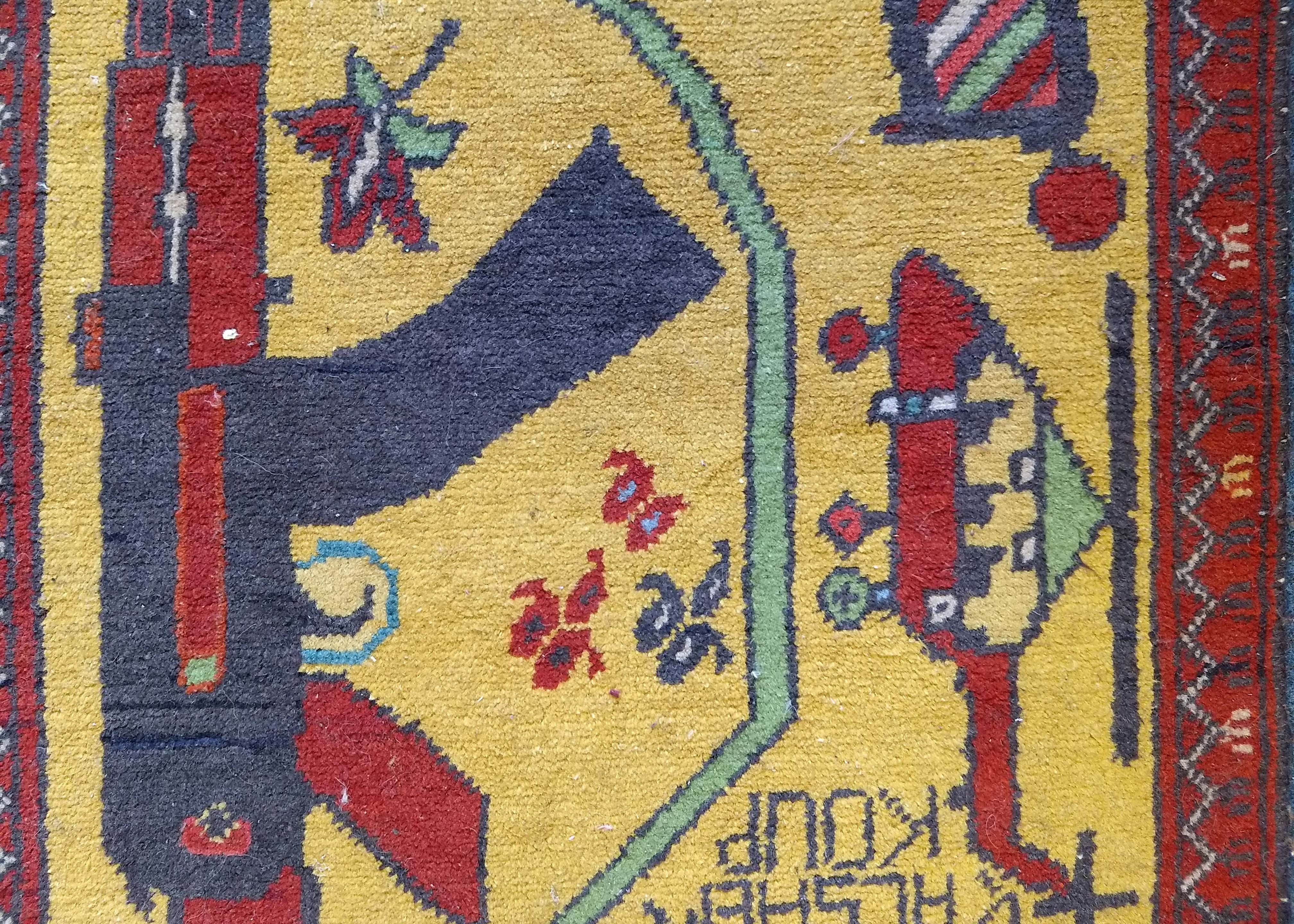 An Afghan woollen war rug, helicopter, guns and grenades on yellow ground, red patterned border, 100 - Image 2 of 3