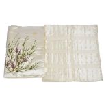 Two early 20th Century padded covers, decorated with hand embroidered heather upon cream silk and