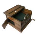 A portable Pathephone, London' model, in oak case with hinged half-lid, hinged door to horn at side,