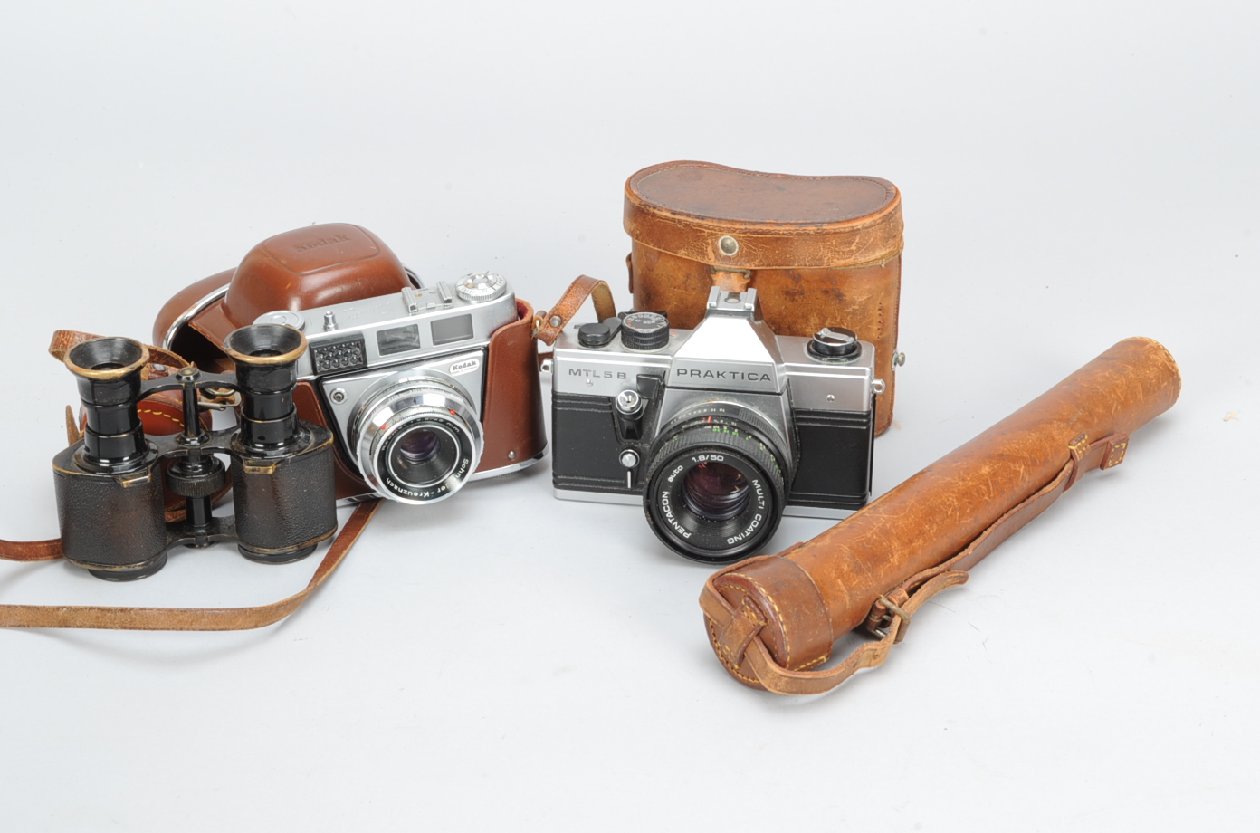 Two 35mm Cameras and Accessories, a Praktica MTL 5B SLR camera, shutter working, meter untested with