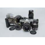 An Olympus OM2n Outfit, with 50mm f/1.4 auto-s, 24mm f/2.8 auto-w, 35-70mm f/4 auto zoom, 75mm-150mm